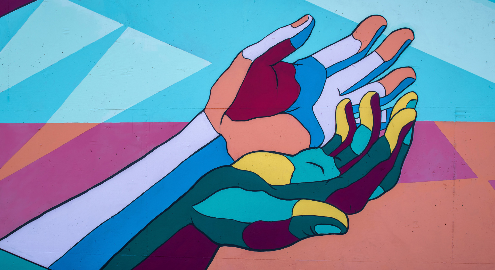 Ilustración de un par de manos de muchos colores.
